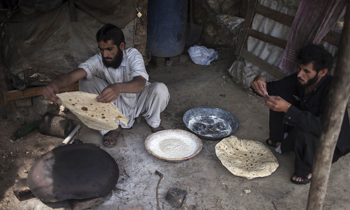 A miner cooks Pashtun roti after finishing his shift at a coal mine in Choa Saidan Shah, Punjab province