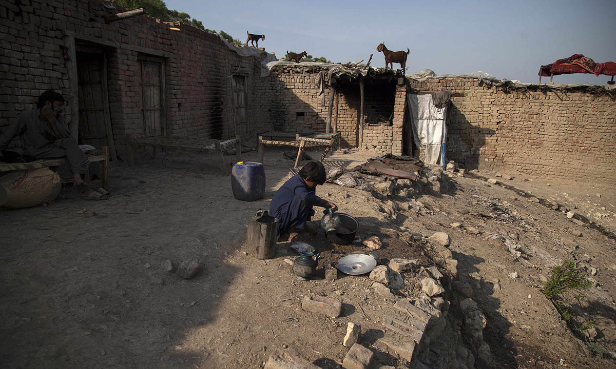 Samiullah washes dishes at a coal mine in Choa Saidan Shah, Punjab province