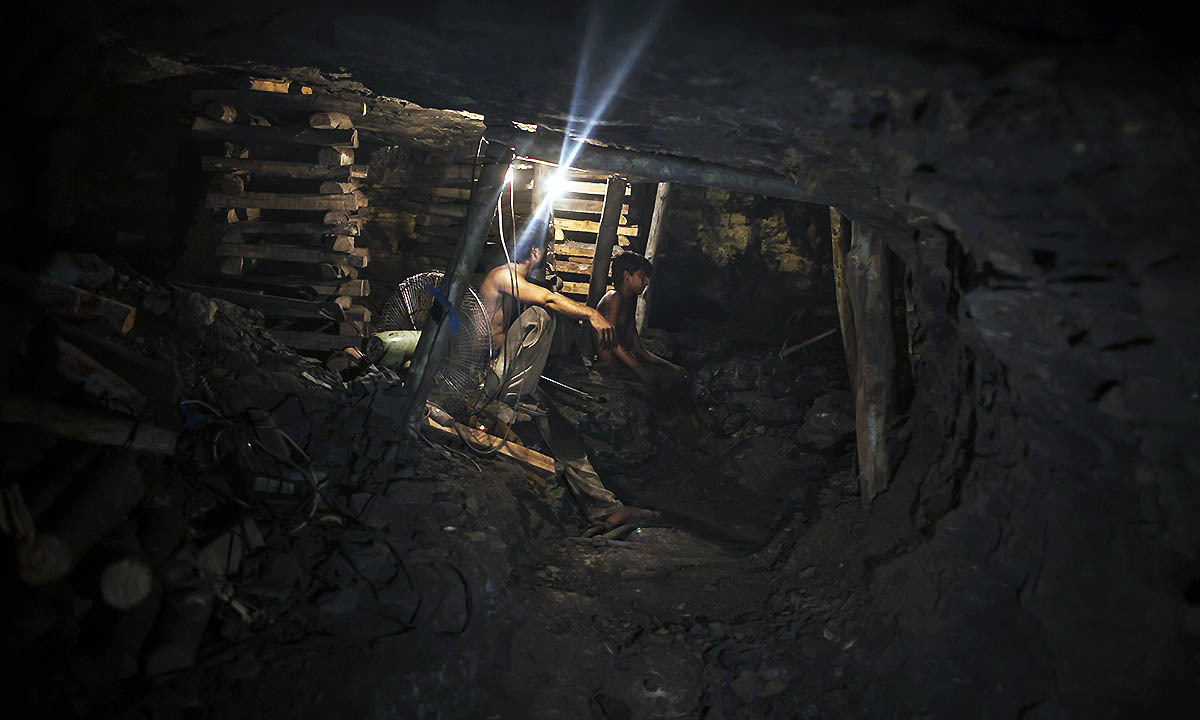 Samiullah sits at the coal face to observe the process of coal mining, underground in Choa Saidan Shah, Punjab province
